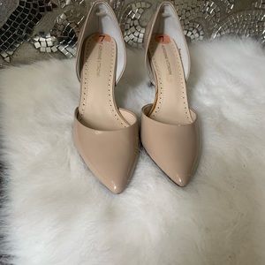 Nude patten leather pointy heels.
